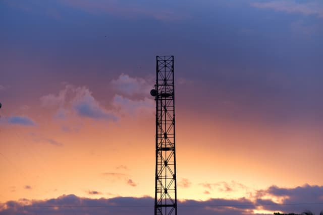 a tower with a sunset in the background