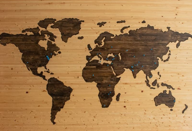 A world map inlaid into a wooden wall panel